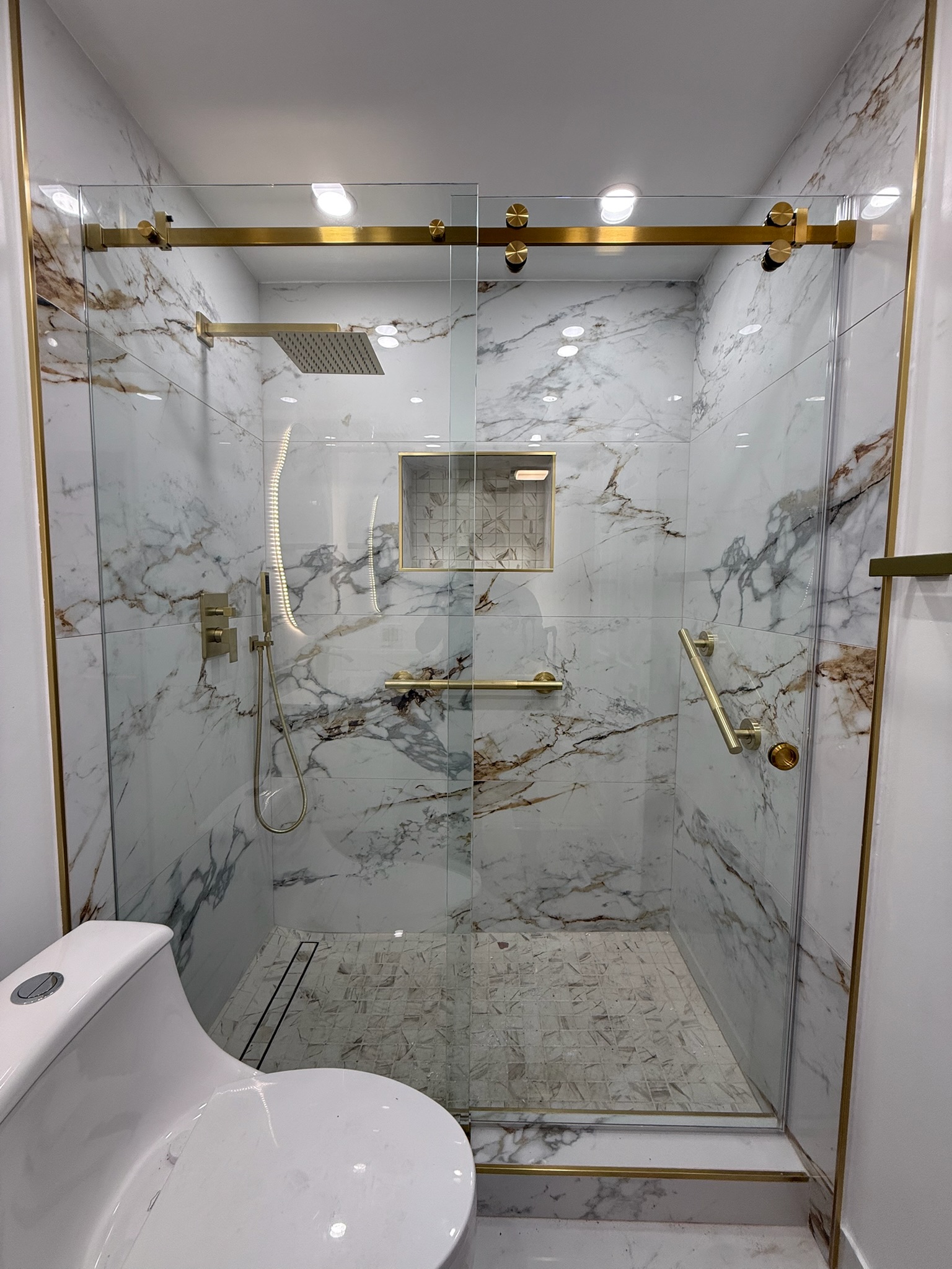 Marble Shower & Gold Trim project by Worldwide Floors Corp in Miami-Dade or Broward