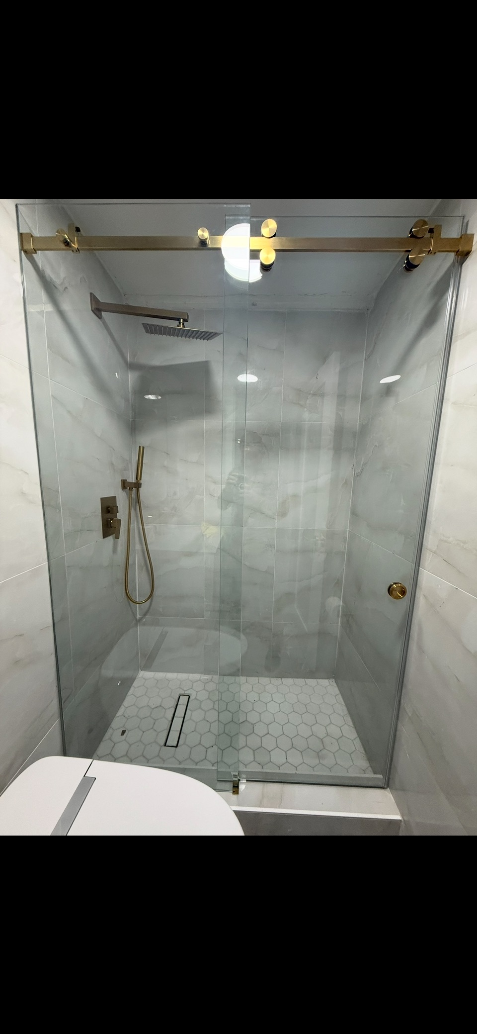 Marble Shower & Gold Fixtures project by Worldwide Floors Corp in Miami-Dade or Broward